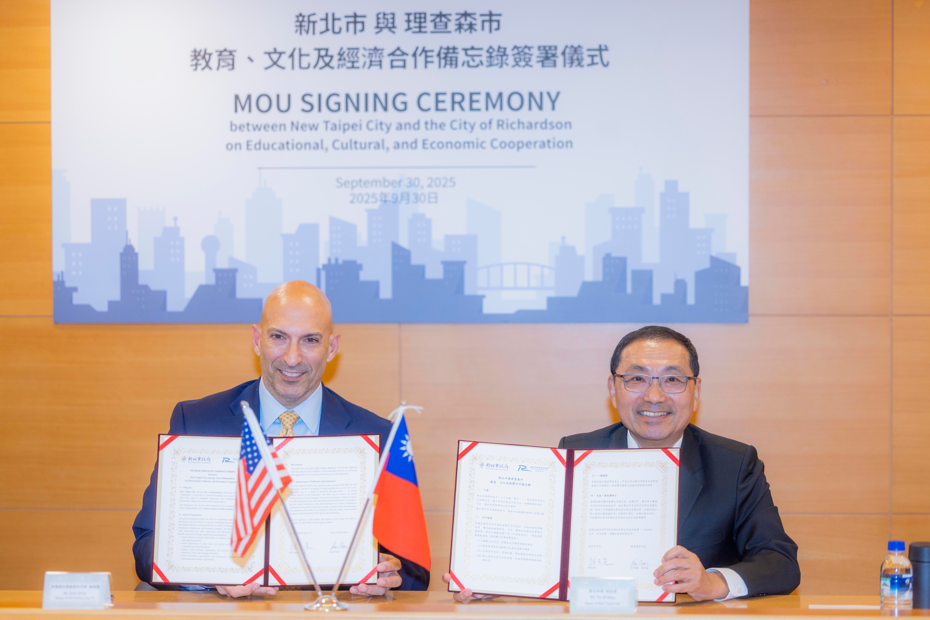 Mayor Hou and Mayor Omar (left) present the MOU.