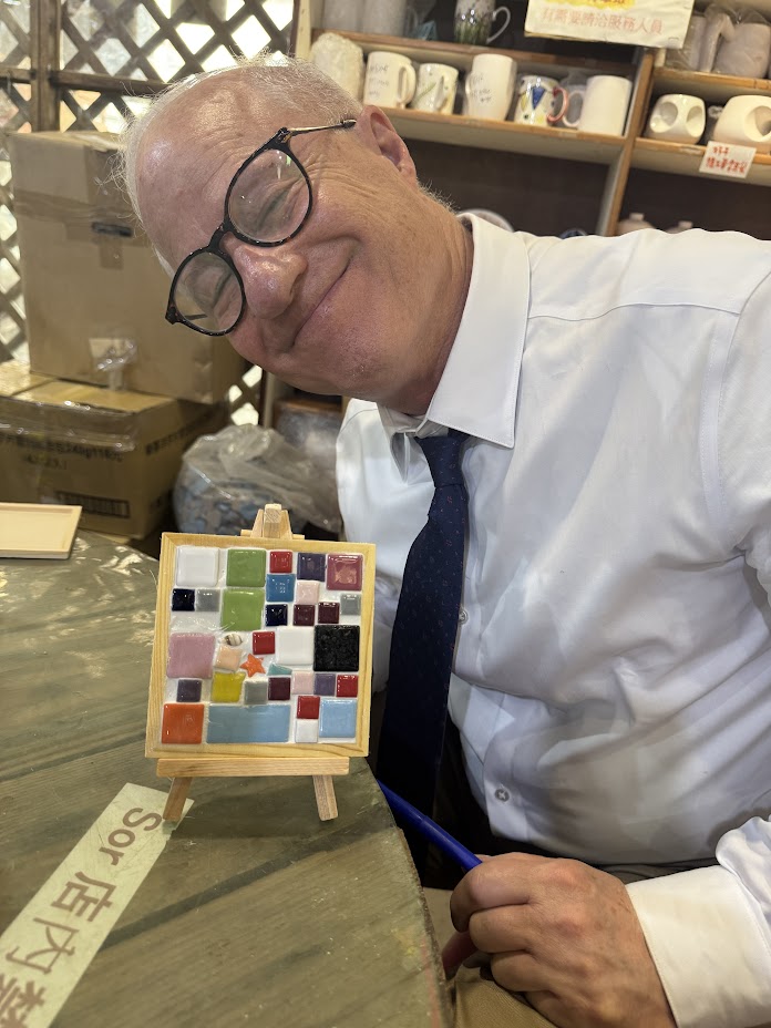 Mayor Coffman with his handmade mosaic tile on a cultural tour to Yingge