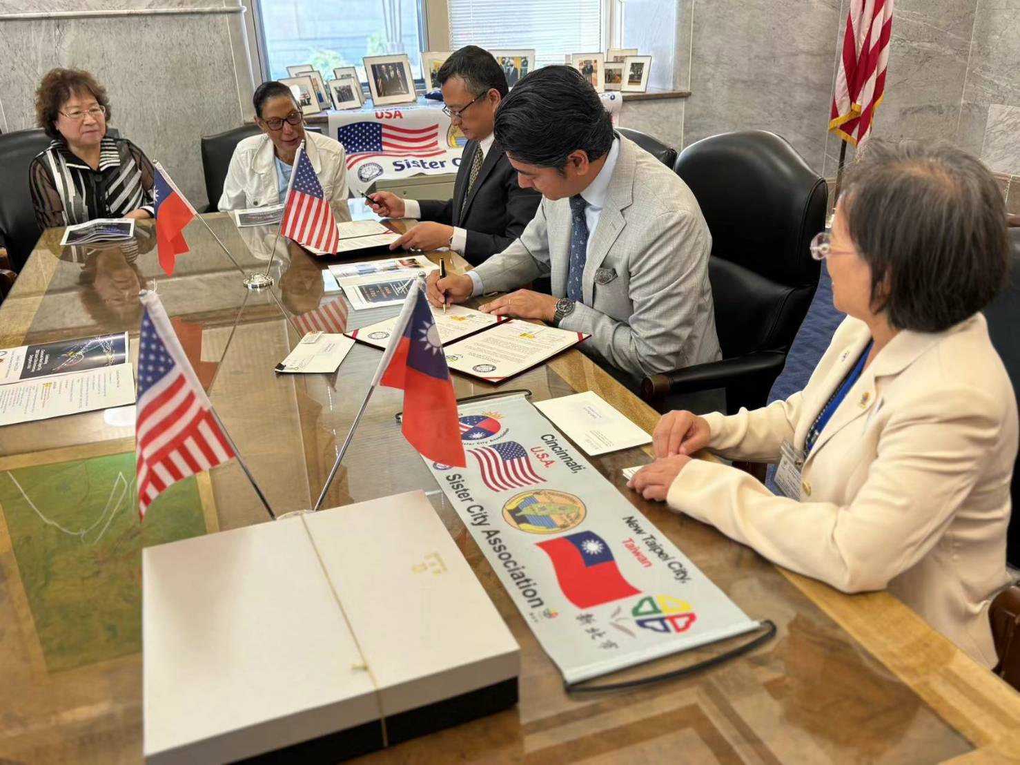 Cincinnati Mayor Aftab Pureval (second from right) signs the sister city agreement and declares the day 